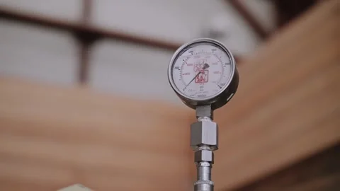 Pressure meter dial with scale and valve in treatment plant workshop closeup. Stock Footage 316161931