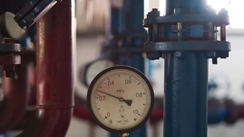 Pressure meter on hot steam pipe in mechanical premise Stock Footage 243299800