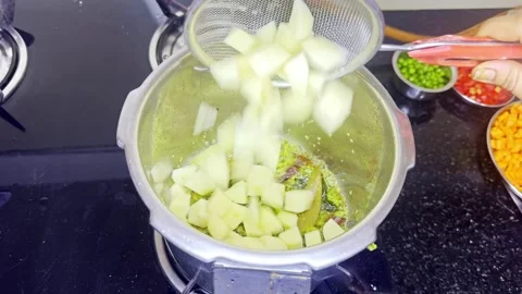Pressure vessel warms over flame filled with veggie mix Stock Footage 310288857