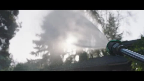 Pressure Washer Blasting Into the Sky in Slow Motion Against a Glaring Sun Stock Footage 265645873