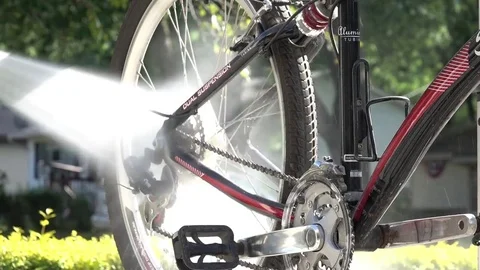 Pressure washing bicycle to remove dirt and sand. Stock Footage