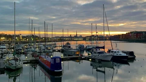 PRESTON Docks, UK 2024 Dec 03; December sunrise reflections of moored yachts. 4k Stock Footage 294522435