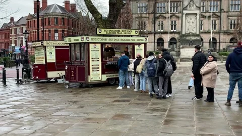 Preston, UK 01/25/2024 A queue for Hot Potatoes at mobile catering van Stock Footage 262651987