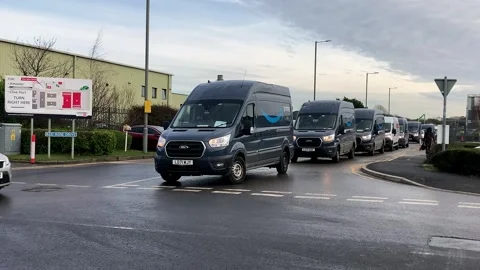 Preston, UK 02/07/2024 Amazon on-line delivery vehicles departing depot Stock Footage 263890933