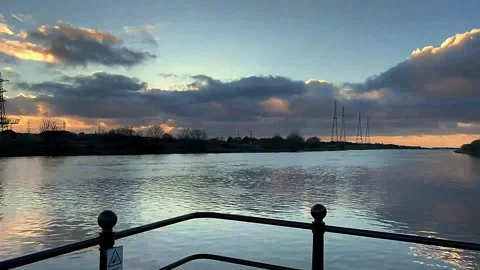 Preston,  UK. 2024 Dec 19; Sunset, Bull Nose entrance to Docks. 4k Video Stock Footage 295998094