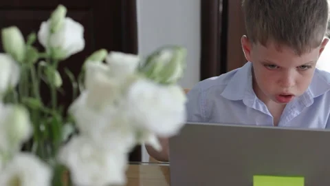 Preteen attentively completes a computer based assignment. 動画素材 310616734
