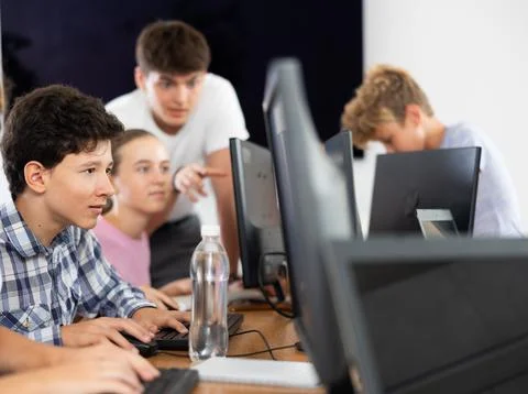 Preteen boy working with computer programs in training room Foto stock