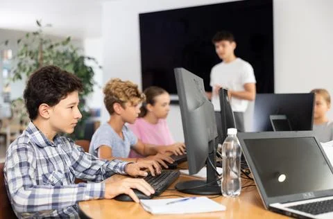Preteen boy working with computer programs in training room 写真素材