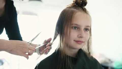 Preteen girl during haircut | Stock Video | Pond5