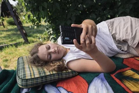 Preteen girl relaxing in summer garden, country life in germany Stock Photos