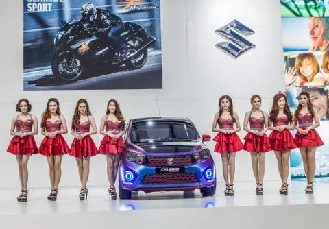 Prettty model with Suzuki Celerio on display Stock Photos