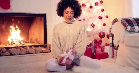Pretty african american woman holds christmas gift Stock Footage