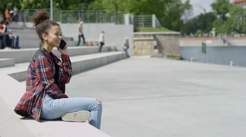 Pretty african student having conversation by phone in the city. 動画素材 63393792