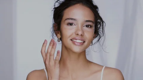 Pretty afro woman touching her face in cheek zone and smiling Stock Footage 123727294