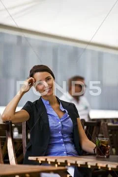Pretty and young woman sitting outdoor Stock Photos