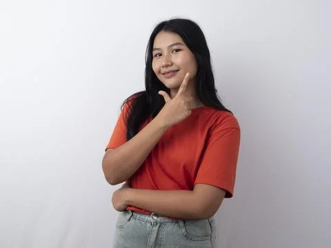 A pretty asian Model smiling while looking away from the camera. With her h.. Stock Photos
