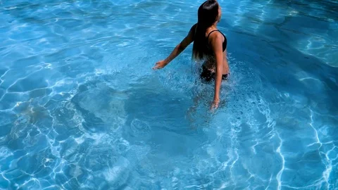 Pretty athletic girl doing a forward roll underwater in a swimming pool Stock Footage 119366122
