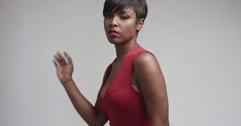 Pretty black young woman in tight red jersey dress Stock Footage