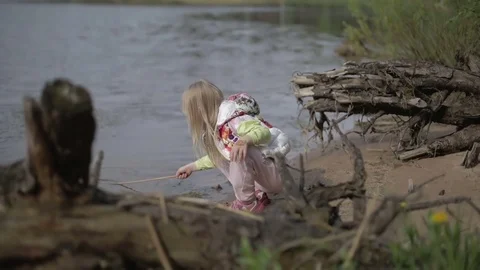 Pretty blond girl with a pattern on the face  fishing in the lake. Stock Footage 70833125