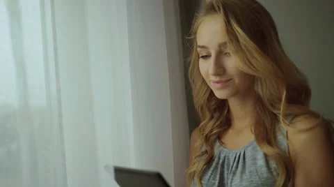 Pretty blond lady using tablet Stock Footage 68720811