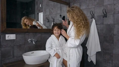 Pretty blond mother having fun together with her smiling little son while Stock Footage 120306053