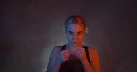 Pretty Blonde Female Boxer Throwing Punches Towards The Camera.Intensely Staring Stock Footage 109558880