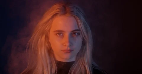 Pretty Blonde Female Model. Staring Down The Lens Intensely In Smoke Stock Footage 109561941