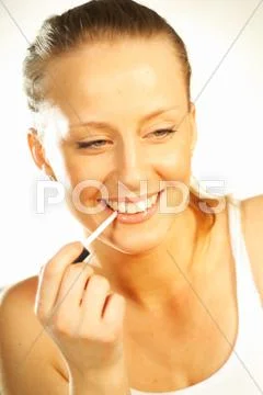 Pretty blonde girl doing makeup Stock Photos