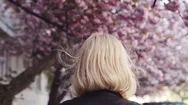 Pretty Blonde Girl In Leather Jacket Enjoying The Cherry Blossom In The City Stock Footage