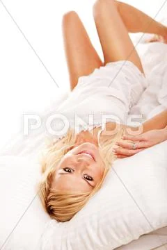 Pretty blonde hugging her pillow in the morning Stock Photos