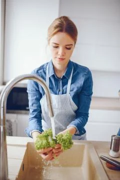 Pretty blonde in a kitchen Stock Photos