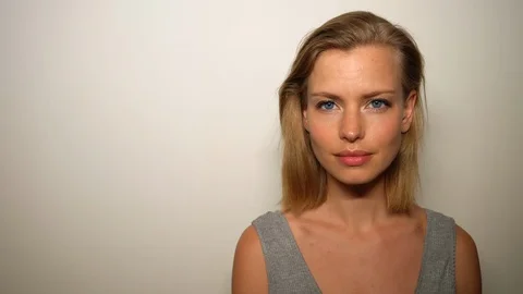 Pretty Blonde Model Against the White Wall Acting Surprised Stock Footage 115508685