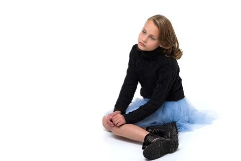 Pretty blonde sitting on the floor in the studio Stock Photos