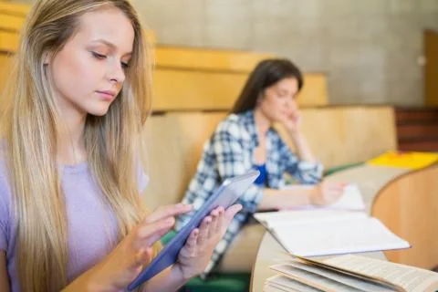 Pretty blonde student using tablet 写真素材