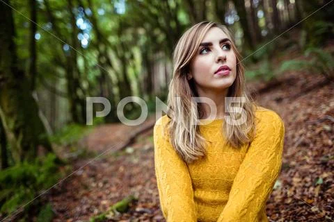 Pretty Blonde Woman Day Dreaming Standing In The Forest