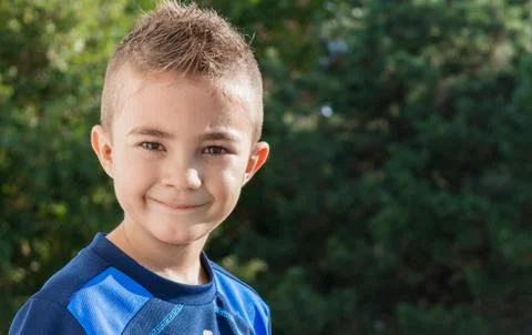 Pretty boy looking at camera outdoors shot Stock Photos