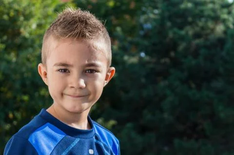 Pretty boy looking at camera outdoors shot Stock Photos