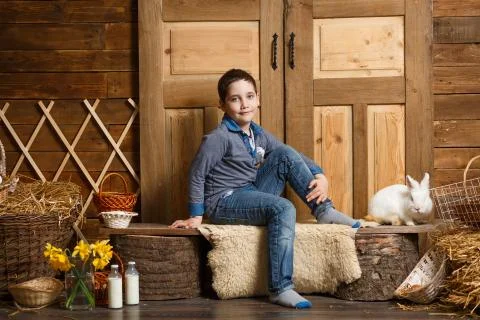 Pretty boy playing with Easter bunny in a Studio Foto stock