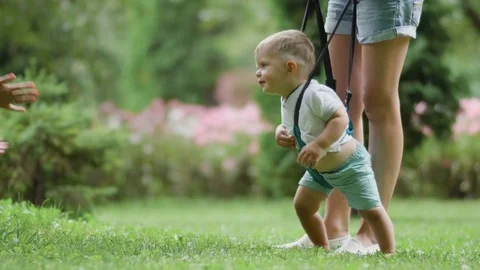 Pretty boy wearing sling springs and tries to walk Stock Footage 80351734