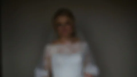 Pretty bride looking out of window and smiling on her wedding day Stock Footage 83013386