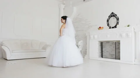 Pretty bride posing to photographer in white studio Video stock 35995764