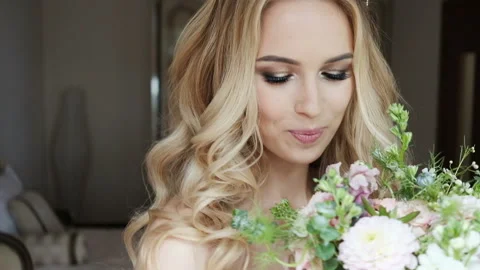 Pretty bride with wedding bouquet looking at camera and smiling. Stock Footage 85497518