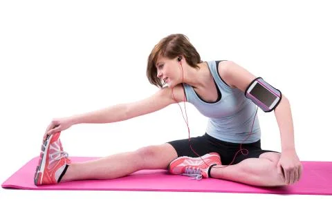 Pretty brunette doing the hamstring stretch on exercise mat 写真素材