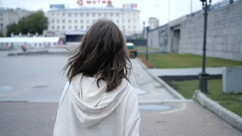 Pretty brunette is looking at camera while walking Stock Footage 91893693