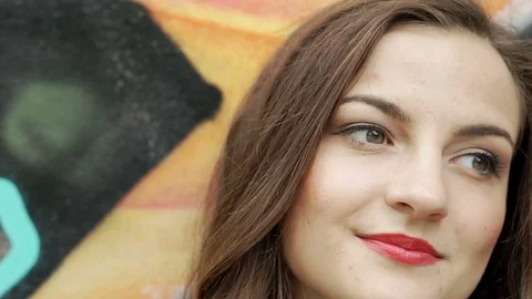 Pretty brunette with red lips looks very happy, steadycam shot Video stock 79362653