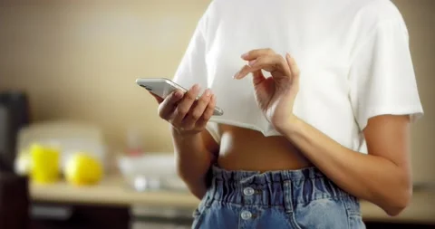 Pretty brunette talking on the phone in the kitchen Stock Footage 176231038