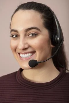 Pretty call center operator with a beaming smile.. Stock Photos