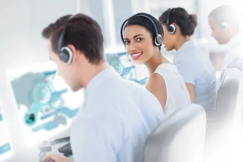 Pretty call center worker using futuristic interface hologram Foto stock