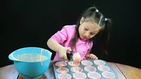 Pretty child making cupcakes Stock Footage 11037339