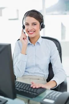 Pretty classy brown haired operator answering a call Stock Photos